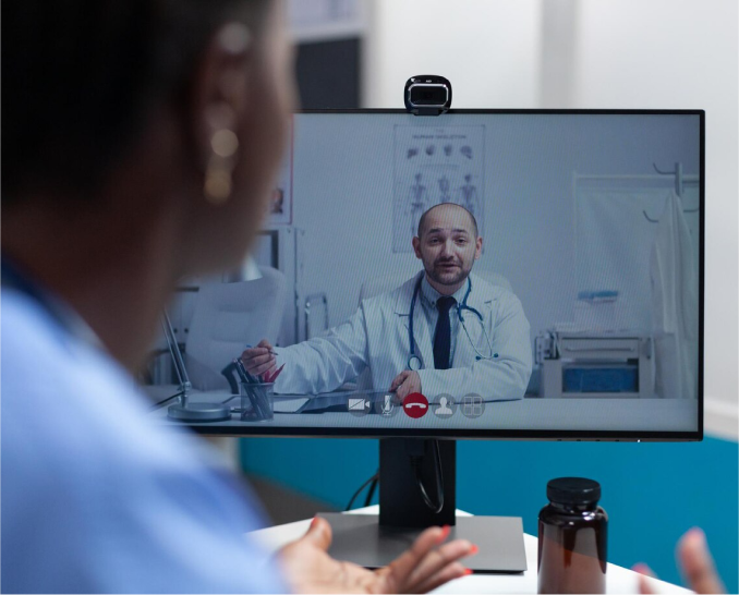 Healthcare professional using a laptop with holographic medical icons